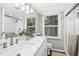 Bright bathroom with double sink vanity, framed mirrors and a glass door shower at 5613 Ashton Dr, Raleigh, NC 27612