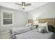 Neutral guest bedroom featuring twin beds, a ceiling fan, and a window for natural light at 5613 Ashton Dr, Raleigh, NC 27612