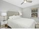 Bedroom with a ceiling fan, neutral decor, a large window and a queen-sized bed at 5613 Ashton Dr, Raleigh, NC 27612