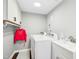 Efficient laundry room featuring a white washer, dryer, sink and plenty of storage space at 5613 Ashton Dr, Raleigh, NC 27612