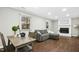 Cozy living room with wood-look floors, fireplace, and a comfortable seating area at 5613 Ashton Dr, Raleigh, NC 27612