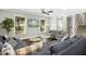 Spacious living room with large windows, comfortable seating, and modern lighting at 5613 Ashton Dr, Raleigh, NC 27612