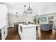 Open concept living area with kitchen island, dining table and sectional sofa at 5613 Ashton Dr, Raleigh, NC 27612