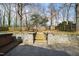 Landscaped backyard with hot tub and stone stair access at 5819 Windham Dr, Raleigh, NC 27609