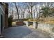 Large backyard featuring a hot tub and stone-walled patio and stair access at 5819 Windham Dr, Raleigh, NC 27609