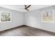 Bedroom features hardwood floors, neutral paint, a modern ceiling fan and ample natural light at 5819 Windham Dr, Raleigh, NC 27609