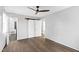 Empty bedroom with gray walls, hardwood flooring, and a barn door closet at 5819 Windham Dr, Raleigh, NC 27609