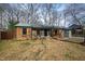 Beautiful brick home with shutters, front porch, and mature trees creating a cozy atmosphere at 5819 Windham Dr, Raleigh, NC 27609