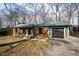 Charming brick home with an attached garage and mature trees creating a serene outdoor space at 5819 Windham Dr, Raleigh, NC 27609
