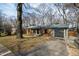 Charming brick home with an attached garage and mature trees in a quiet neighborhood at 5819 Windham Dr, Raleigh, NC 27609