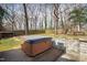 Relax in this backyard hot tub featuring a privacy fence and mature trees at 5819 Windham Dr, Raleigh, NC 27609