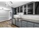 This kitchen features stainless steel appliances, sleek gray cabinetry, and hardwood floors at 5819 Windham Dr, Raleigh, NC 27609