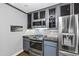Charming kitchen features stainless steel appliances, gas range, custom cabinetry, and modern finishes at 5819 Windham Dr, Raleigh, NC 27609