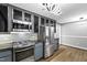 Charming kitchen features stainless steel appliances, gas range, custom cabinetry, and modern finishes at 5819 Windham Dr, Raleigh, NC 27609