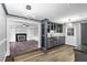 Open-concept kitchen with stainless steel appliances, custom cabinets, and view of the living room at 5819 Windham Dr, Raleigh, NC 27609