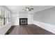 Bright living room featuring hardwood floors, white built-ins, fireplace, and natural light at 5819 Windham Dr, Raleigh, NC 27609