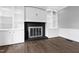 Living room features hardwood floors, a black tile fireplace, and white built-in shelving at 5819 Windham Dr, Raleigh, NC 27609