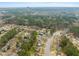 Aerial view showcases neighborhood, mature trees, and business buildings in distance at 5913 North Hills Dr, Raleigh, NC 27609