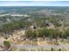 Overhead aerial view of the neighborhood with mature trees and a lake in the background at 5913 North Hills Dr, Raleigh, NC 27609
