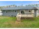 Back of gray home with a wooden deck and stairs at 5913 North Hills Dr, Raleigh, NC 27609