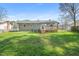 Spacious backyard features green grass, a privacy fence, and a back deck at 5913 North Hills Dr, Raleigh, NC 27609