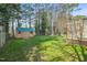 Large backyard with green grass and mature trees features a storage shed at 5913 North Hills Dr, Raleigh, NC 27609