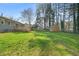 View of the sprawling backyard, back of house, and storage shed at 5913 North Hills Dr, Raleigh, NC 27609