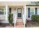 Close-up of the front entrance showcasing the stylish door and brick steps at 5913 North Hills Dr, Raleigh, NC 27609