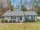 Charming single-story home with gray paint, landscaped front yard at 5913 North Hills Dr, Raleigh, NC 27609