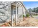 Home entrance with covered porch and white railing at 5913 North Hills Dr, Raleigh, NC 27609