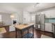 Kitchen view with a large stainless steel refrigerator and fireplace in background at 5913 North Hills Dr, Raleigh, NC 27609