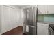 Kitchen featuring stainless steel refrigerator, white cabinets and wood floor at 5913 North Hills Dr, Raleigh, NC 27609