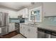 Kitchen with granite countertops, stainless appliances and a large window at 5913 North Hills Dr, Raleigh, NC 27609