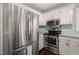 Bright kitchen featuring stainless steel appliances, white cabinets and a subway tile backsplash at 5913 North Hills Dr, Raleigh, NC 27609