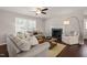 Cozy living room featuring a fireplace, ceiling fan and comfortable seating at 5913 North Hills Dr, Raleigh, NC 27609