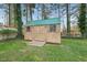 New wood storage shed with metal roof and wood deck is located in the backyard at 5913 North Hills Dr, Raleigh, NC 27609