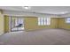 Spacious basement featuring neutral carpet, natural light and sliding glass doors at 6021 Dickson Mill Rd, Durham, NC 27705