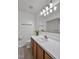 Clean, bright bathroom featuring a new mirror, lighting and a vanity with white countertops at 6021 Dickson Mill Rd, Durham, NC 27705