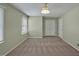 Neutral bedroom with carpet, a window with blinds, closet, and door to the hallway at 6021 Dickson Mill Rd, Durham, NC 27705