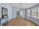 Bright dining room with wood floors, stylish lighting, and a view of the front entryway at 6021 Dickson Mill Rd, Durham, NC 27705