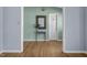 Charming entryway with a decorative mirror, wooden floors, and a view to the front door at 6021 Dickson Mill Rd, Durham, NC 27705