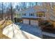 Aerial view of charming home with two car garage and sunny, tree lined property at 6021 Dickson Mill Rd, Durham, NC 27705