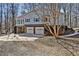Home's exterior features a two-car garage, brick foundation, and light blue siding at 6021 Dickson Mill Rd, Durham, NC 27705