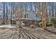 Exterior view of the home with a well-maintained lawn and mature trees in a suburban setting at 6021 Dickson Mill Rd, Durham, NC 27705