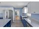Modern kitchen featuring stainless steel appliances, custom cabinets, and views to the entryway at 6021 Dickson Mill Rd, Durham, NC 27705