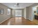 Open living room with hardwood floors, bright walls and glass doors to the outdoor area at 6021 Dickson Mill Rd, Durham, NC 27705