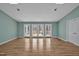 Bright living room with hardwood floors, skylights, and access to an outdoor deck through French doors at 6021 Dickson Mill Rd, Durham, NC 27705