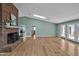 Open living area with hardwood floors, a fireplace, and access to the outdoors at 6021 Dickson Mill Rd, Durham, NC 27705