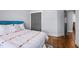 Cozy bedroom features wood floors, gray walls, and a comfortable bed with colorful accents at 608 Dowd St, Durham, NC 27701