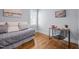 Bright bedroom with a daybed, desk, artwork, and hardwood floors at 608 Dowd St, Durham, NC 27701
